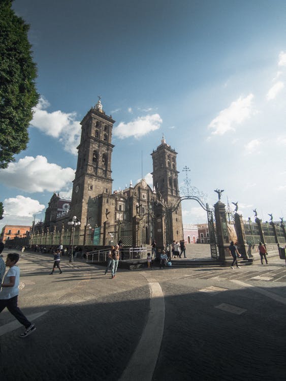 A large cathedral with people walking around it