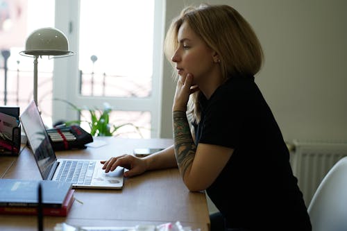 Woman in Black T-shirt Using Laptop Computer