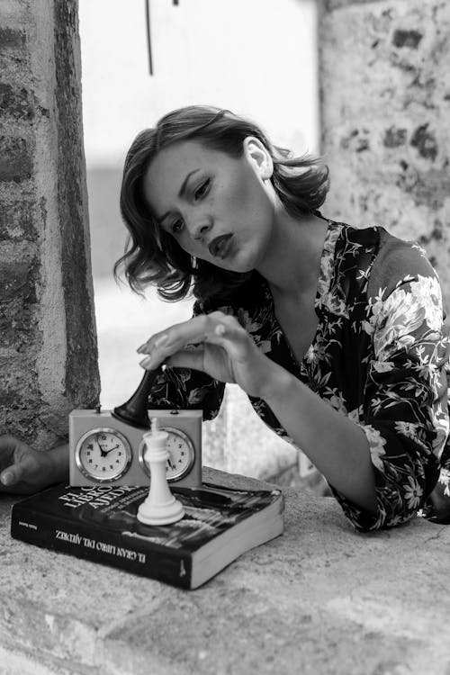 A woman sitting on a bench with a clock