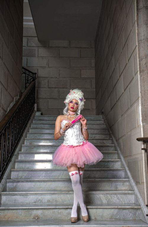 Free Model poses in vintage-inspired fashion on a marble staircase in Mexico City. Stock Photo