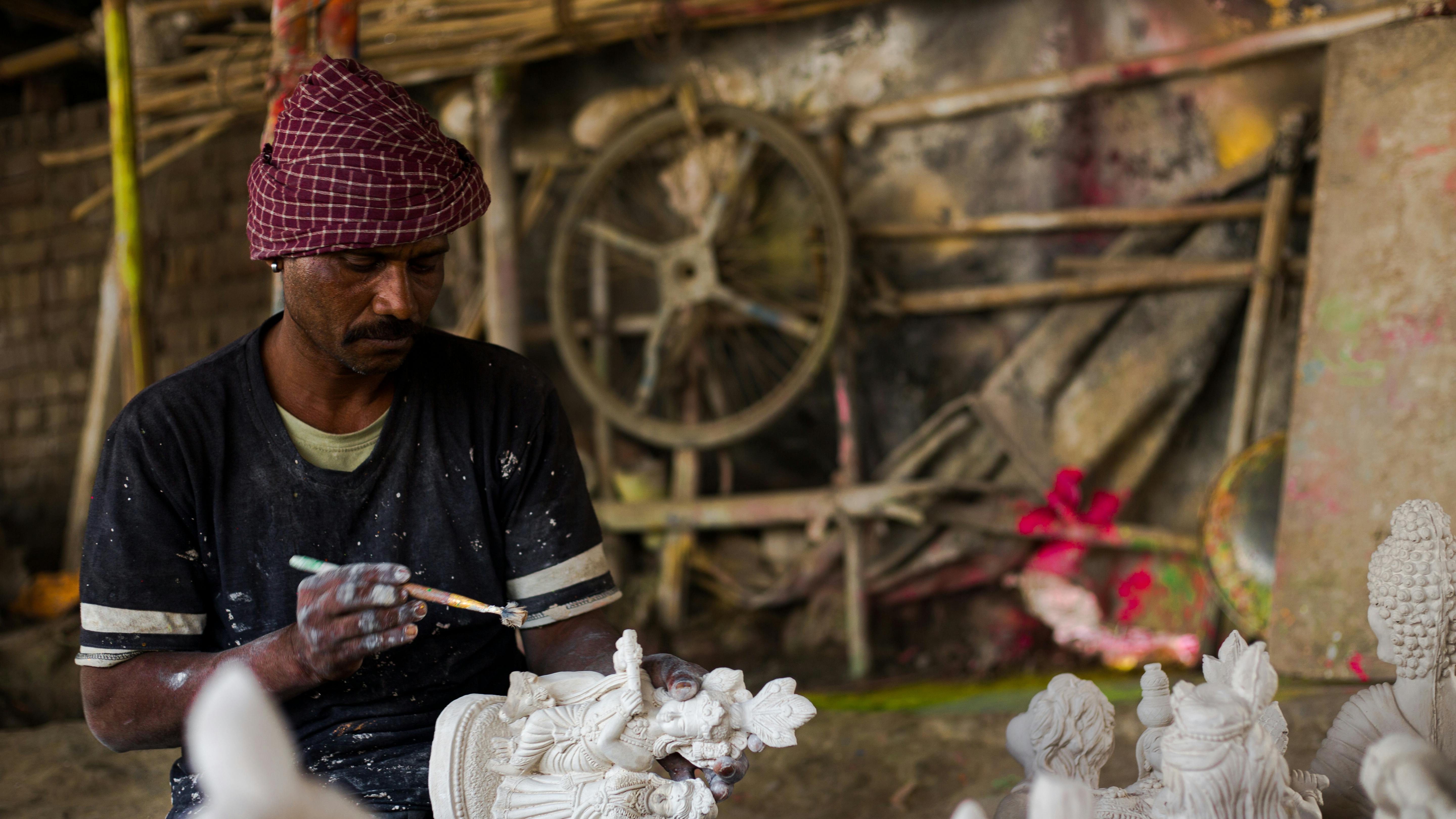 a man is working on a sculpture in a workshop