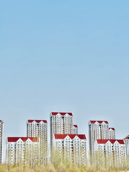 A row of tall buildings with red roofs
