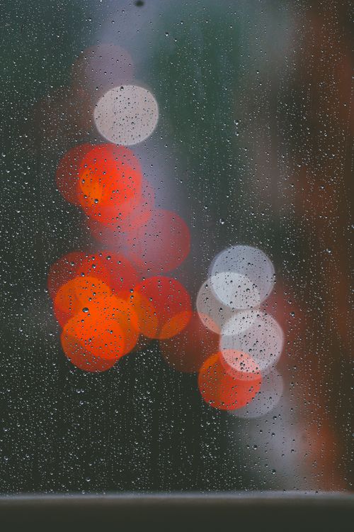 Free Raindrops on a window with colorful bokeh in Jakarta, Indonesia. Stock Photo