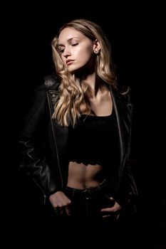 Elegant portrait of a woman in a leather jacket, showcasing modern fashion with a moody aesthetic.