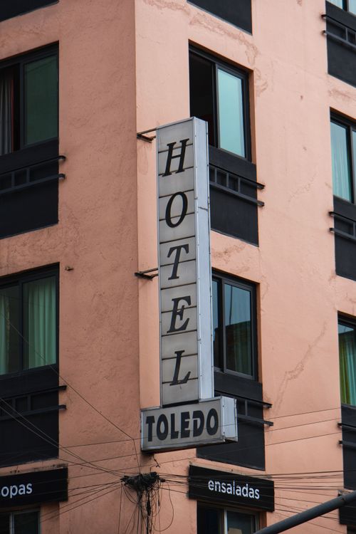 Free Facade of Hotel Toledo in Mexico City, featuring urban architecture with prominent signage. Stock Photo