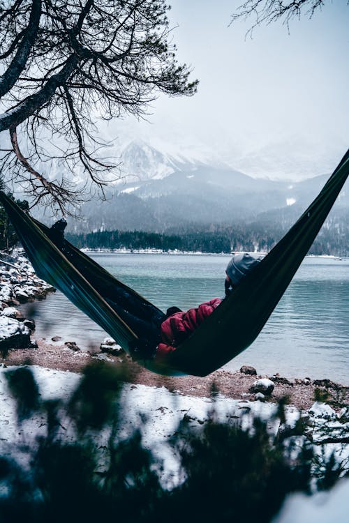 Tourist in a Hammock on the Shore of Eibsee Lake in Winter