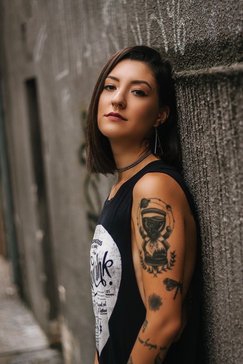 Free Portrait of a stylish tattooed woman in São Paulo, Brazil, exuding confidence and elegance. Stock Photo