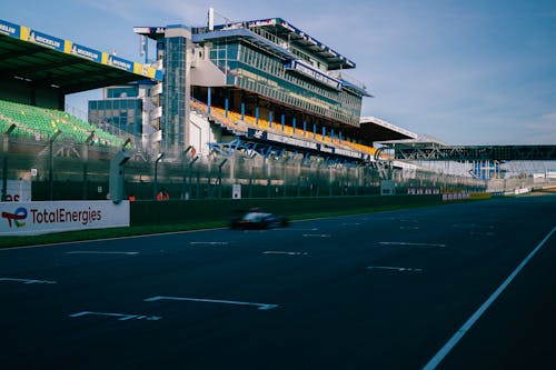 A race track with a large building in the background