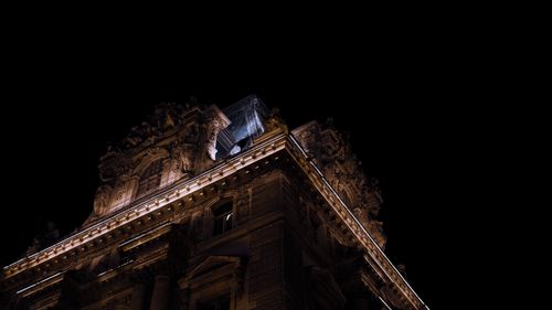 Free A stunning night view of the Louvre Museum's intricate architecture in Paris, France. Stock Photo