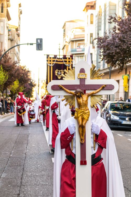 Free Traditional Holy Week procession with people carrying a cross in Zaragoza, Spain. Stock Photo