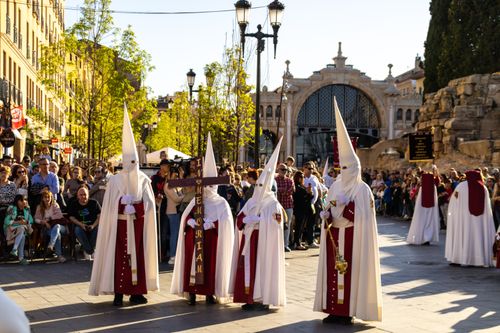 Free Adults in traditional capirotes during a Zaragoza Holy Week procession, a vibrant cultural event. Stock Photo