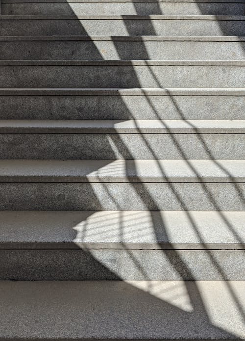 A stairway with a shadow of a person walking up it