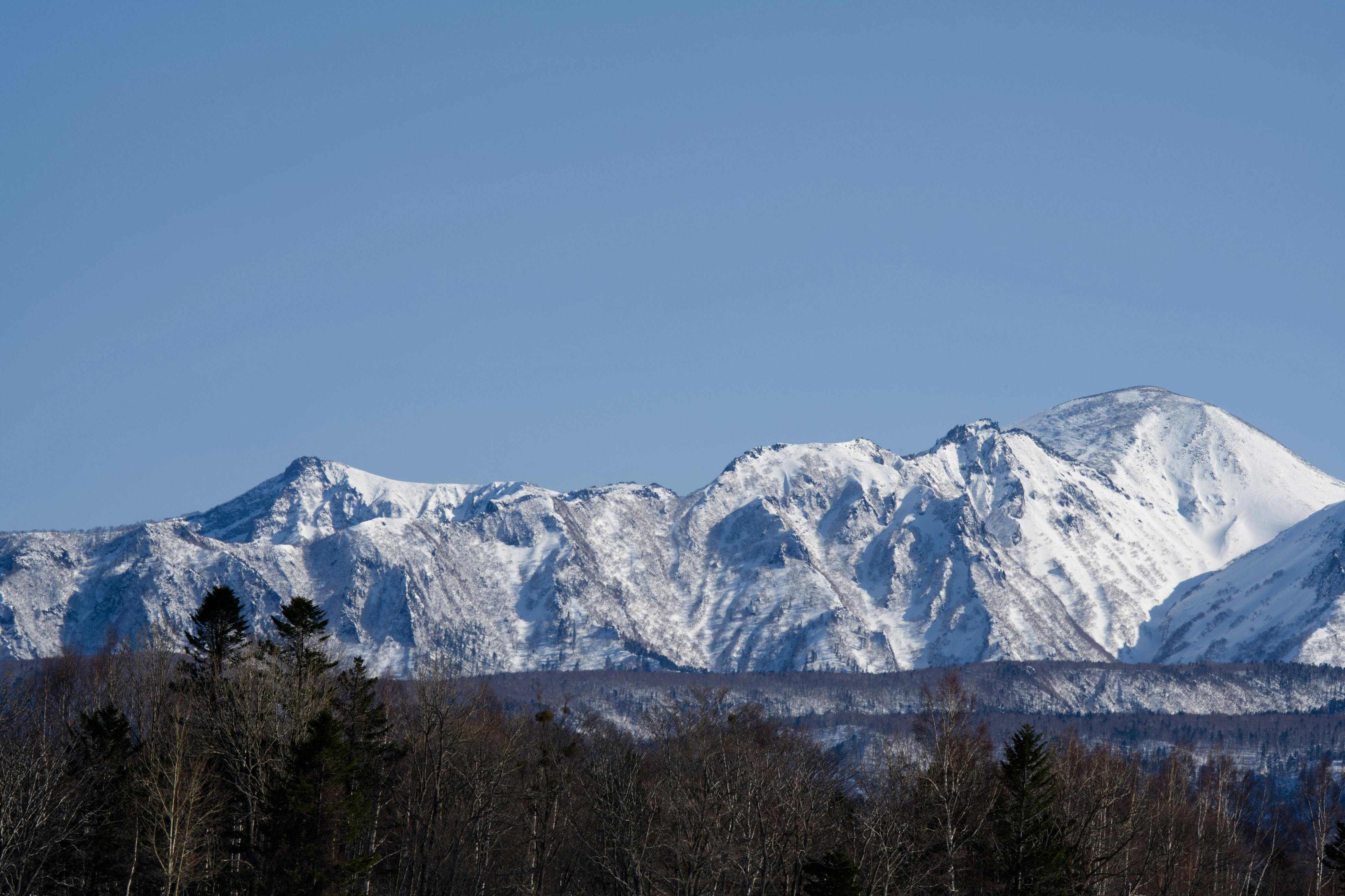 Prescription Goggle Inserts - Stunning view of snowcovered mountains in Hokkaido, Japan under clear skies.