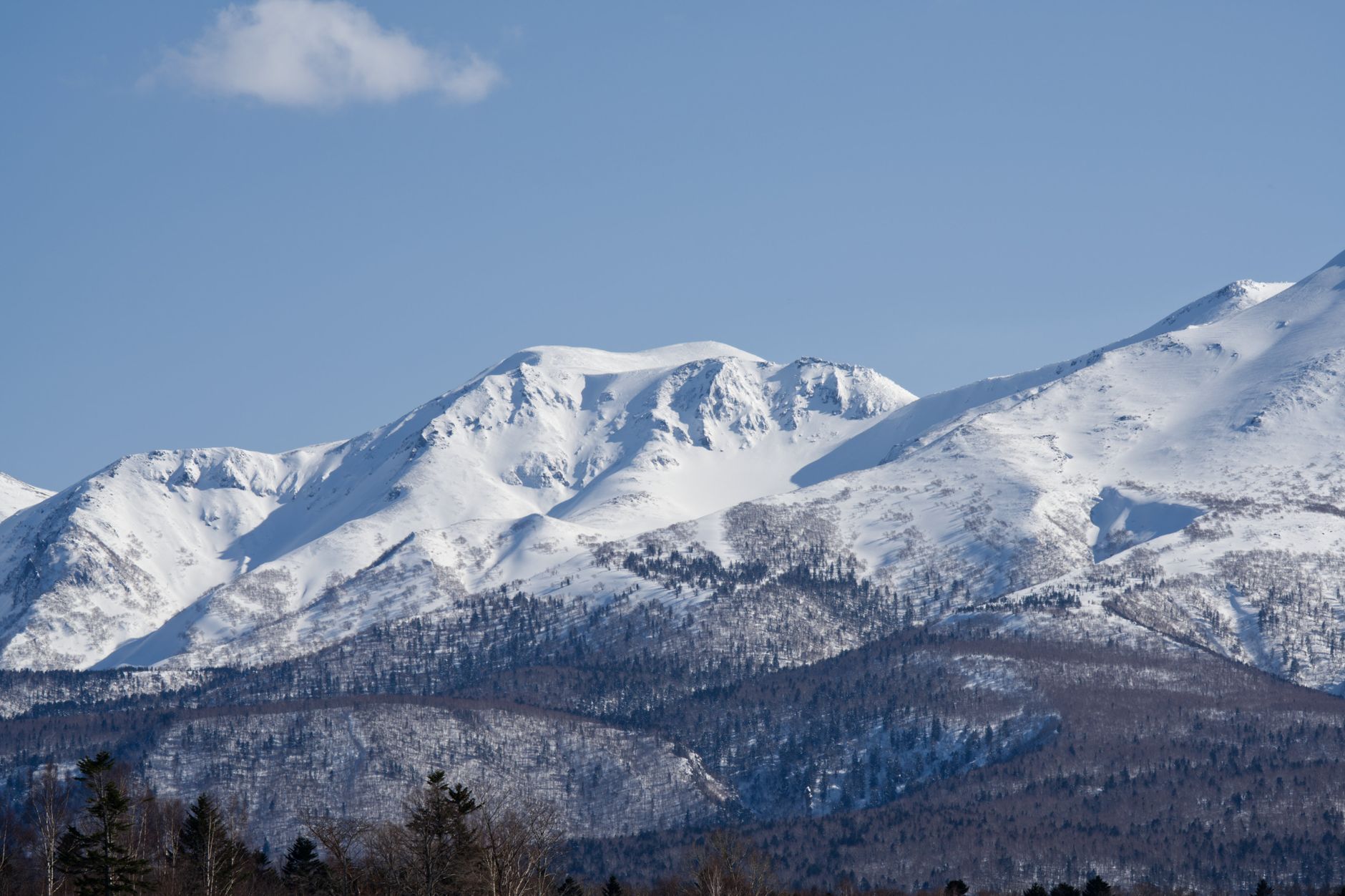 Breathtaking view of snowcapped Mount Asahi in Hokkaido, Japan during winter.