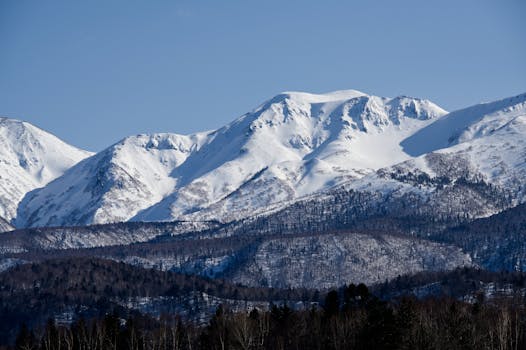 Breathtaking winter view of snow-covered mountains in Daisetsuzan National Park, Hokkaido, Japan.