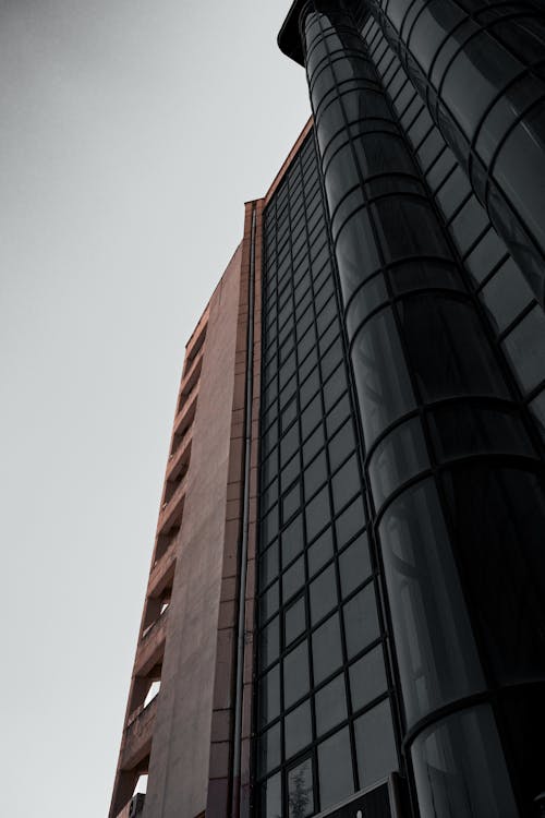 A tall building with windows and a black sky