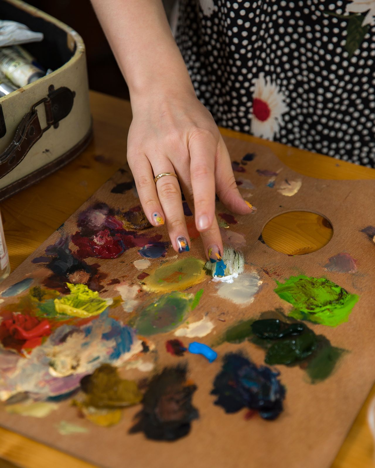 An artist using their finger to pain