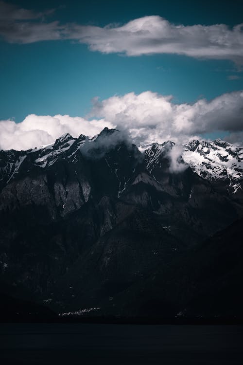 A black and white photo of mountains and clouds