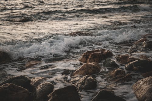 A photo of the ocean with rocks and water