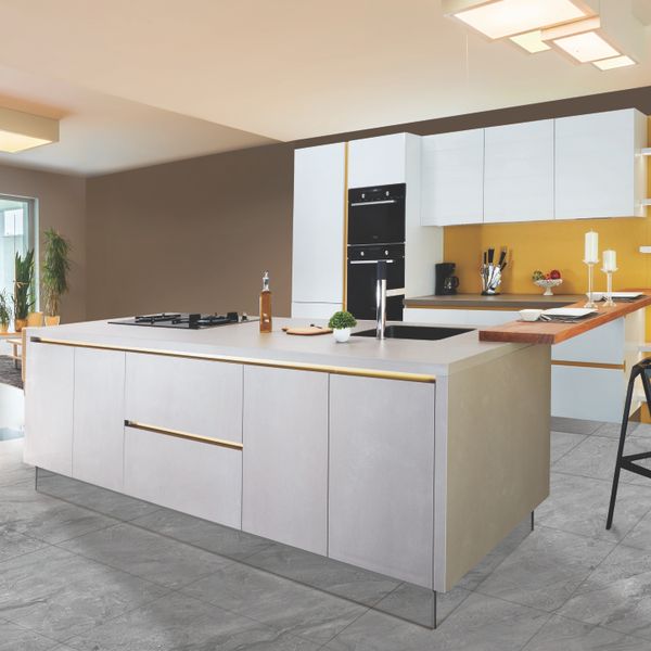 Well-kept kitchen with clear, wiped-down countertops and gleaming appliances
