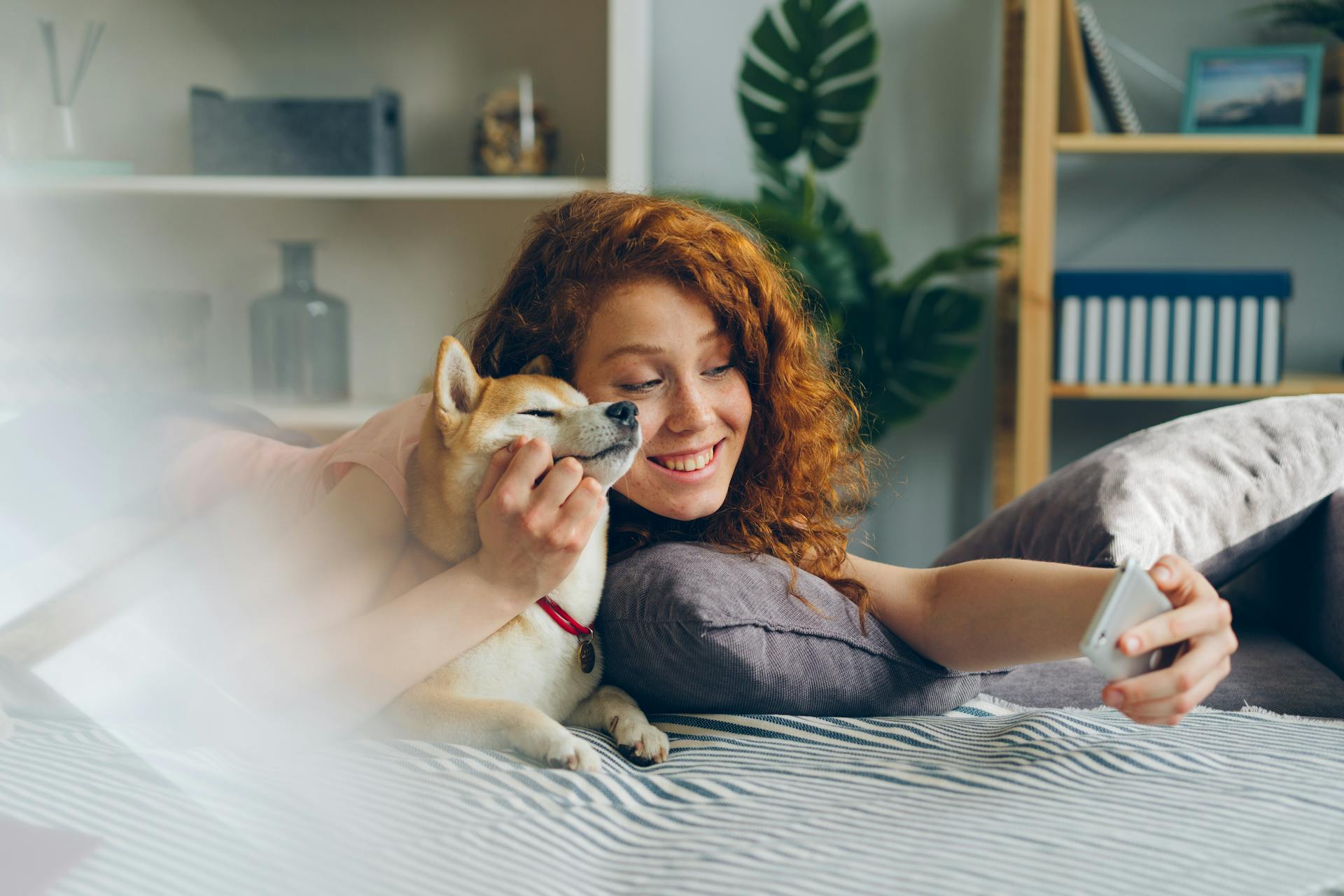 Smiling Woman Taking Selfie with Dog