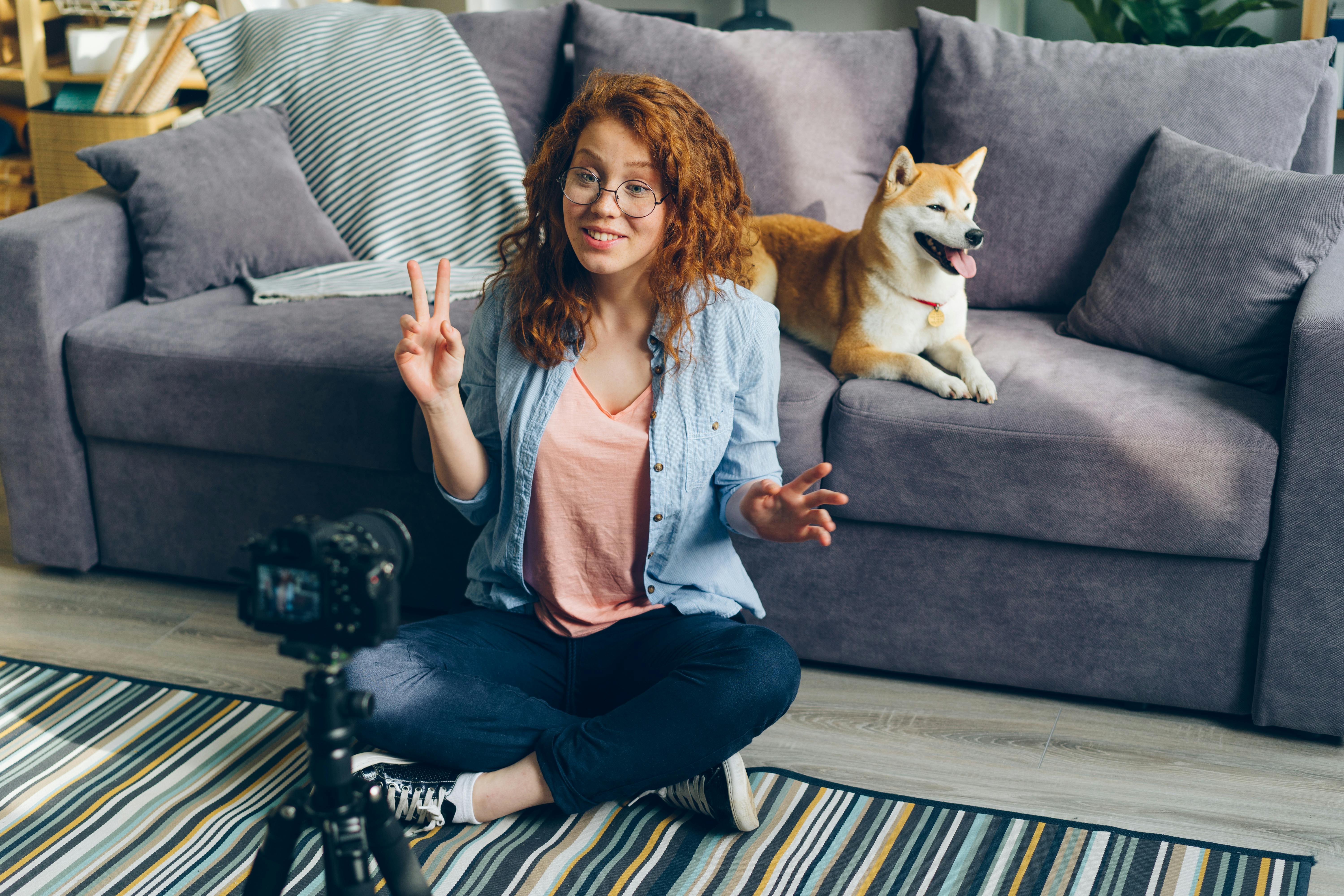 redhead woman recording herself in a living room