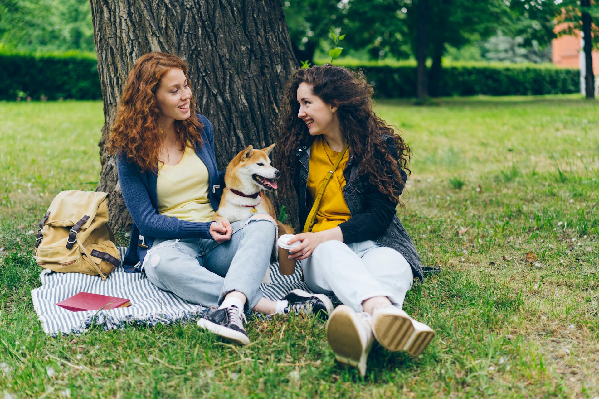 Smiling Friends Sitting with Dog