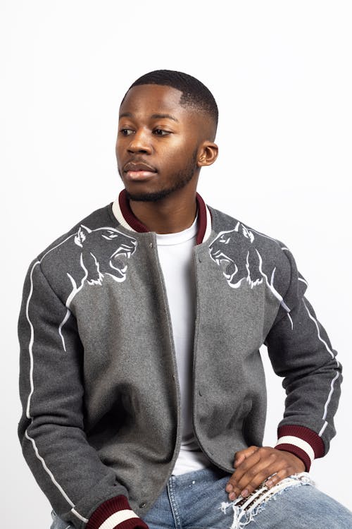 A young man in a gray jacket and jeans