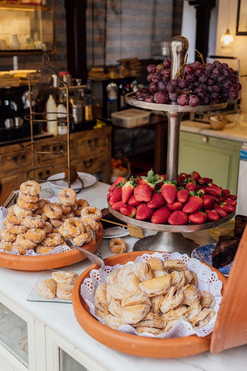 A table with a variety of pastries and fruit