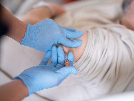 Nurse giving insulin injection to diabetic patient