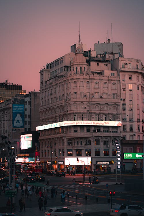 A city street with buildings and people walking