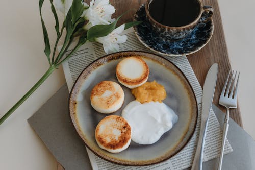 A plate with two eggs and a cup of coffee