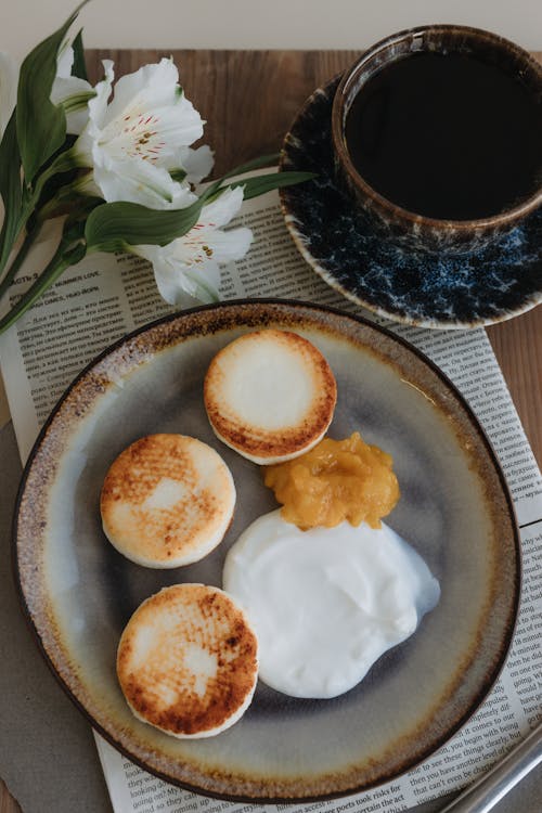 A plate with two biscuits and coffee