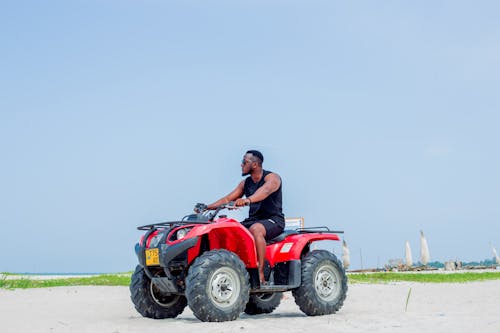 A man riding an atv on the beach