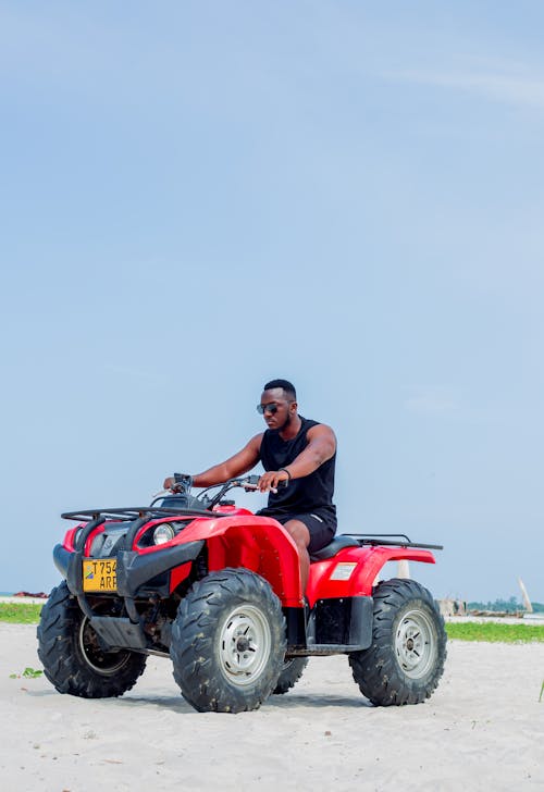 A man riding an atv on a beach