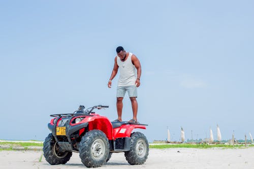 A man standing on top of a quad bike