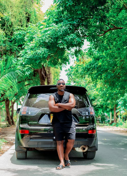 A man standing in front of a black suv