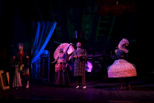 A group of people on stage with a man in a costume