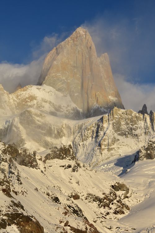 Free Breathtaking view of Mount Fitz Roy covered in snow, capturing the essence of El Chalten's rugged landscape. Stock Photo