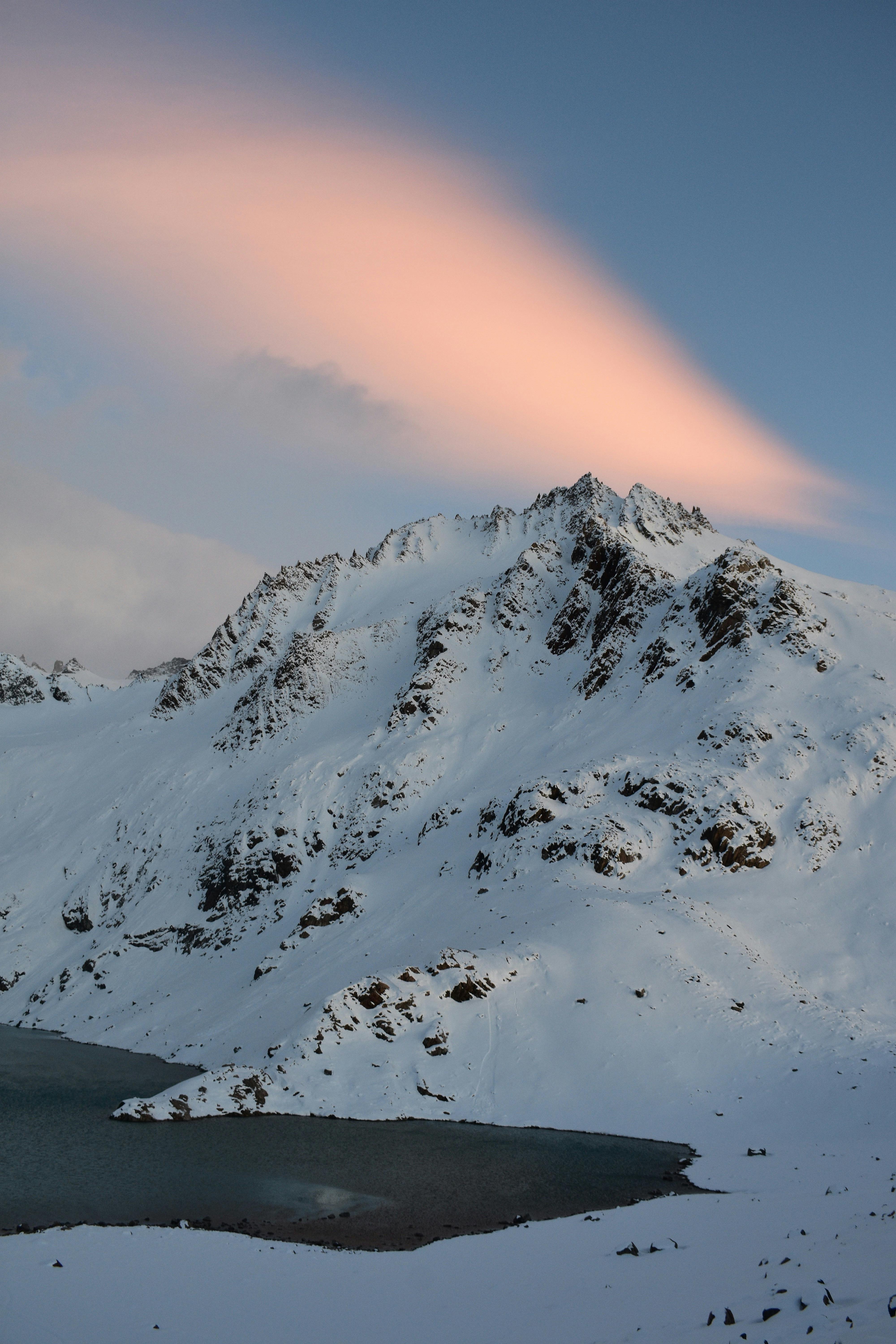 Beautiful winter landscape of snow-covered mountains and a serene lake in El Chalten, Argentina.