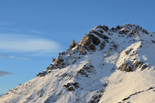 A snow covered mountain with a blue sky