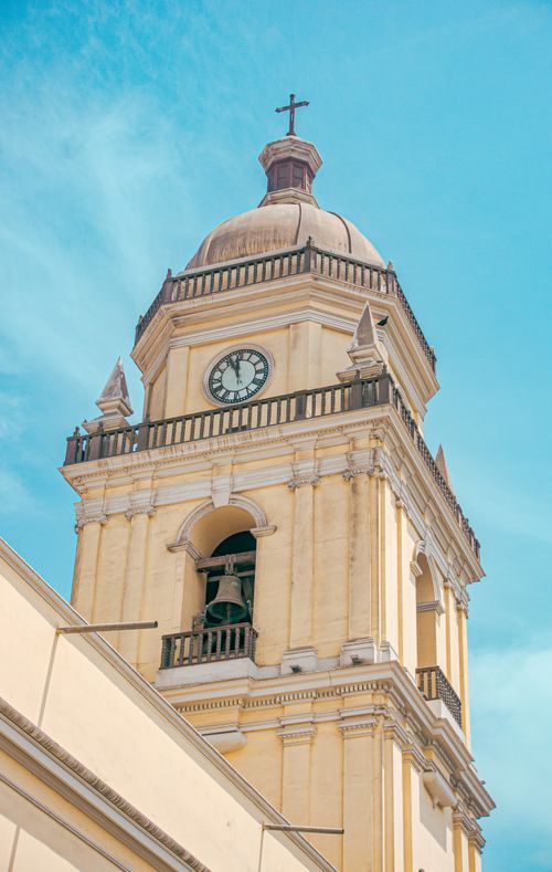 Free Neoclassical bell tower facade in Lima, Peru under a bright blue sky. Stock Photo