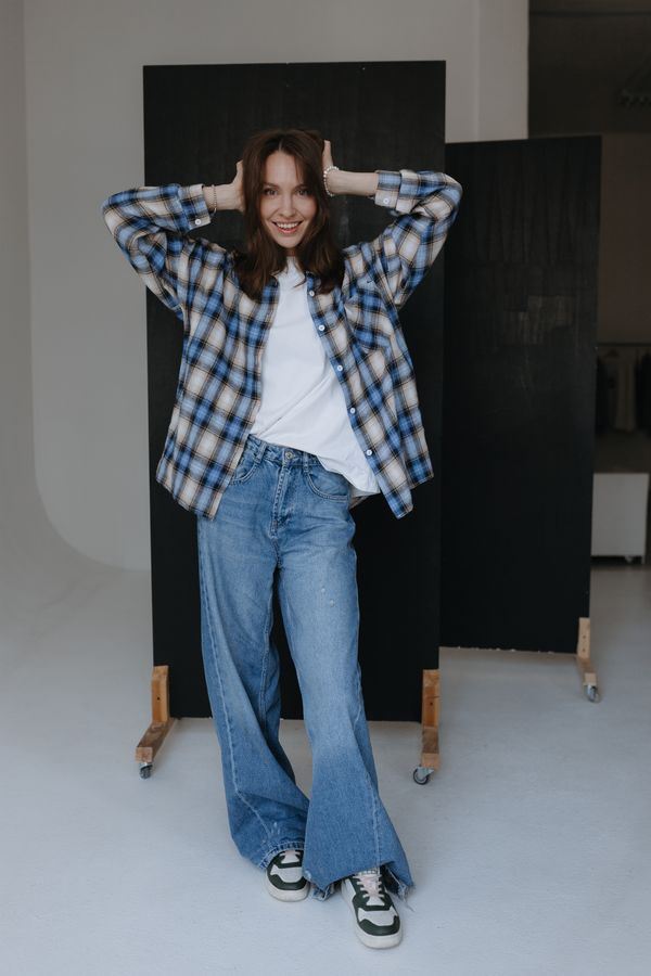 Woman in a red plaid flannel shirt with jeans