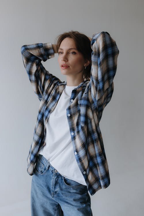 Model in Flannel Shirt over White T-shirt and Jeans Holding Her Hair