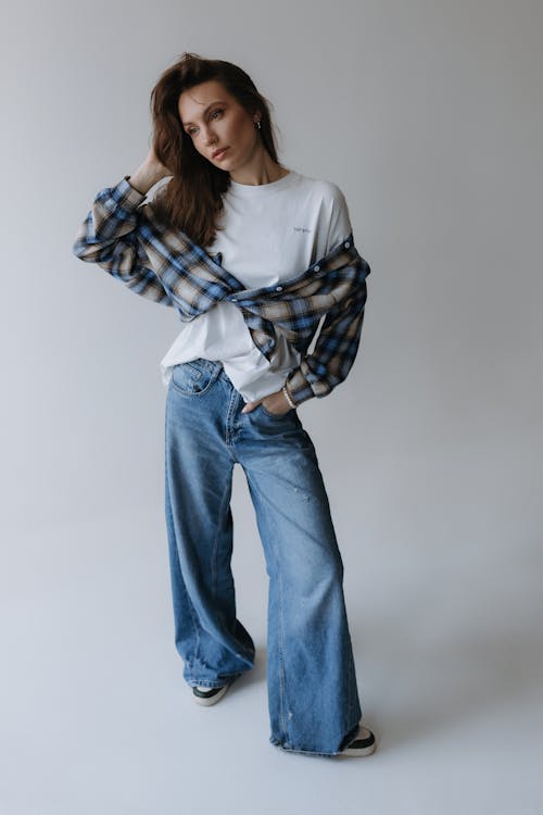 Free Model in a Tied Blouse Over a White T-shirt and Jeans Stock Photo