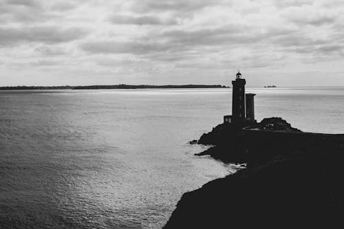 Silhouette of Lighthouse on Sea Coast