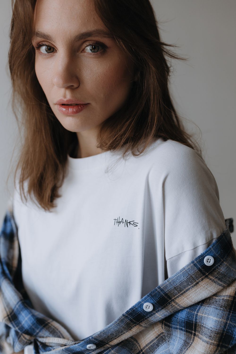 Model Shirt Example Model in a White T-shirt with a Thanks Print and a Flannel Shirt · Free ...