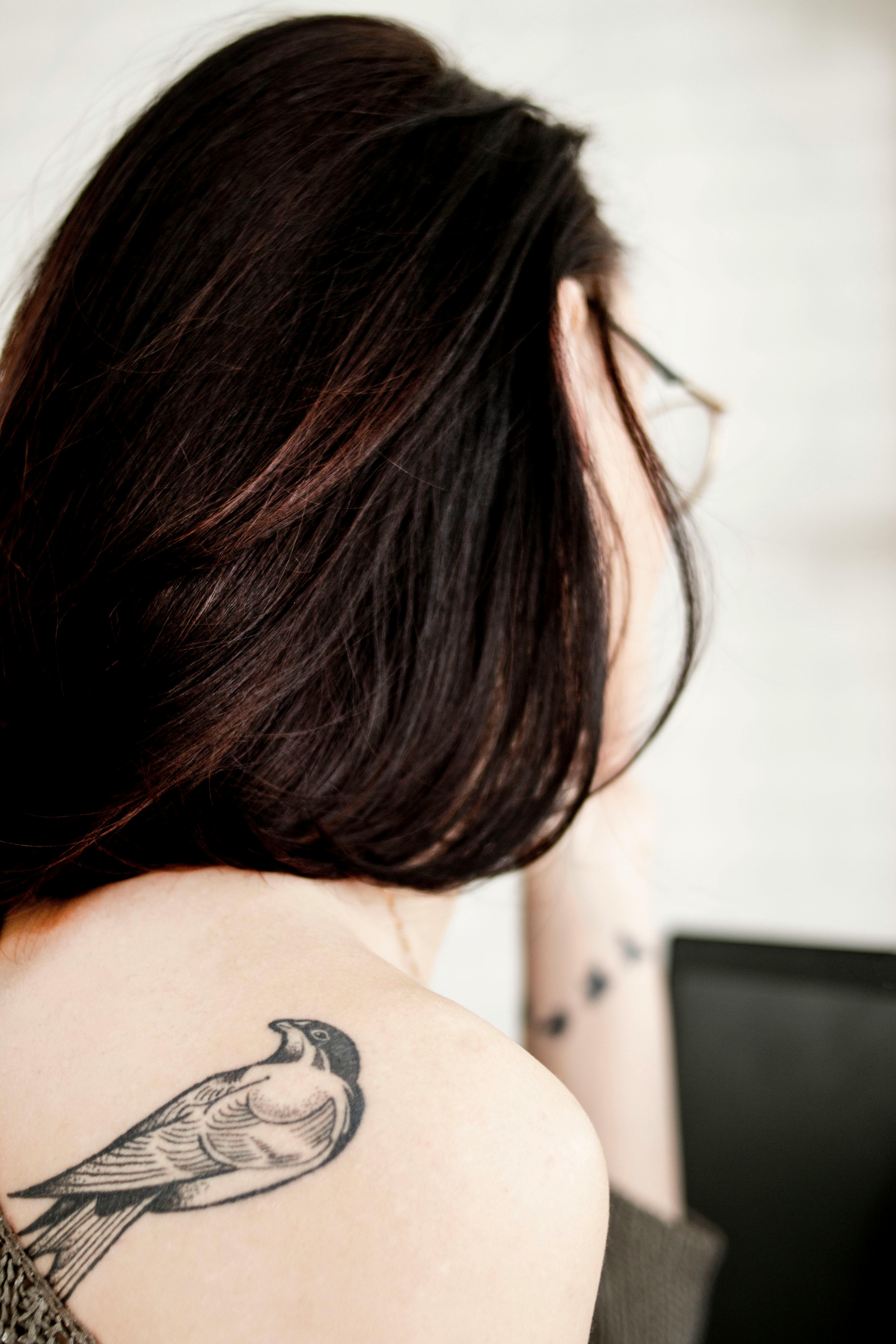 Dotwork flying birds and branch tattoo on the shoulder