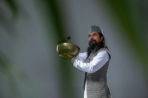 A man in a long beard holding a bowl