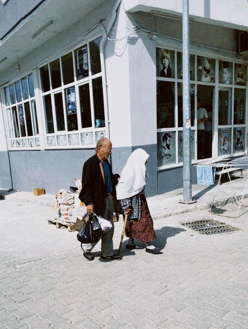 Free An elderly couple walking together in a city street, showcasing daily life in Nazilli, Aydın, Türkiye. Stock Photo